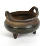 A Chinese bronze tripod incense burner, character mark on base, diameter 12cm