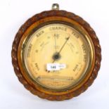 An oak rope-framed aneroid wall barometer and thermometer, by W Last of Sudbury, diameter 29cm