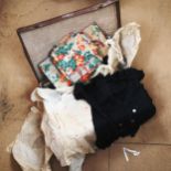 A suitcase containing various fabric, tops etc