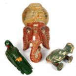 A carved and painted wood Ganesh mask ornament, 38cm, a carved wood parrot, and a pull-along fish