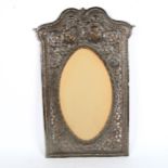 A large Indian unmarked white metal photo frame, internal dimensions 38cm x 22cm, overall 62cm x