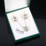 A silver and diamond set pendant necklace and pair of matching earrings