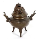 A Chinese patinated bronze incense burner and cover, height 19cm
