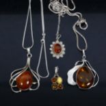 4 silver and amber pendant necklaces, 3 with silver chains