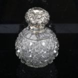 A cut-glass and silver-mounted scent bottle