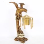 A Chinese carved and painted wood bird of prey table lamp, with silk lantern shade, height 60cm
