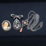 3 Continental silver necklaces, to include a coral set drop pendant, a flower and ribbon drop