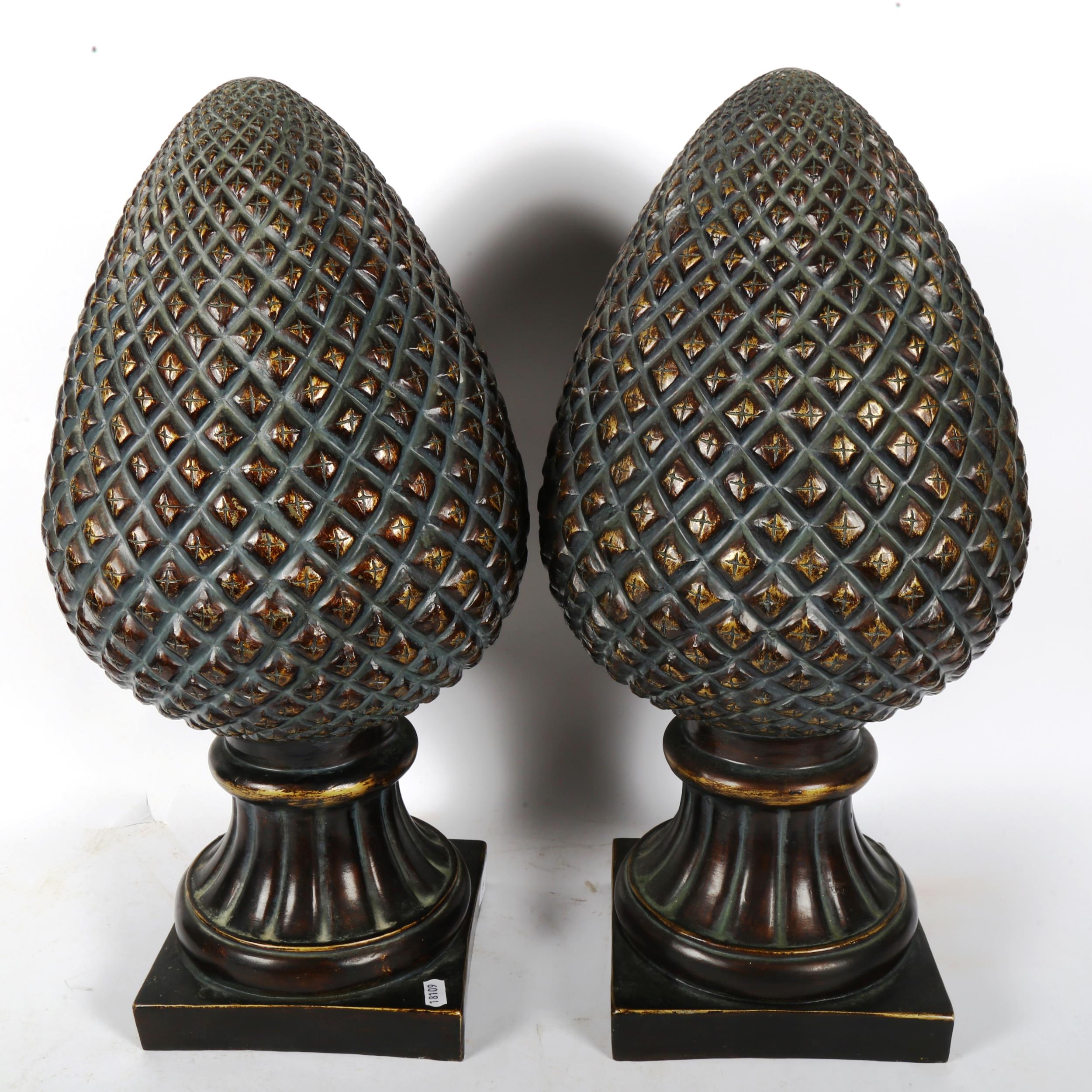 A large pair of resin pineapple finials, height 54cm