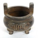 A small Chinese bronze Ding tripod incense burner, diameter 10cm