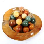 A group of polished hardstone orbs, carved hardwood fruit, mother-of-pearl mounted fruit bowl etc