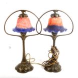 A pair of Tiffany style embossed brass table lamps, with blue and red glass shades, height 45cm