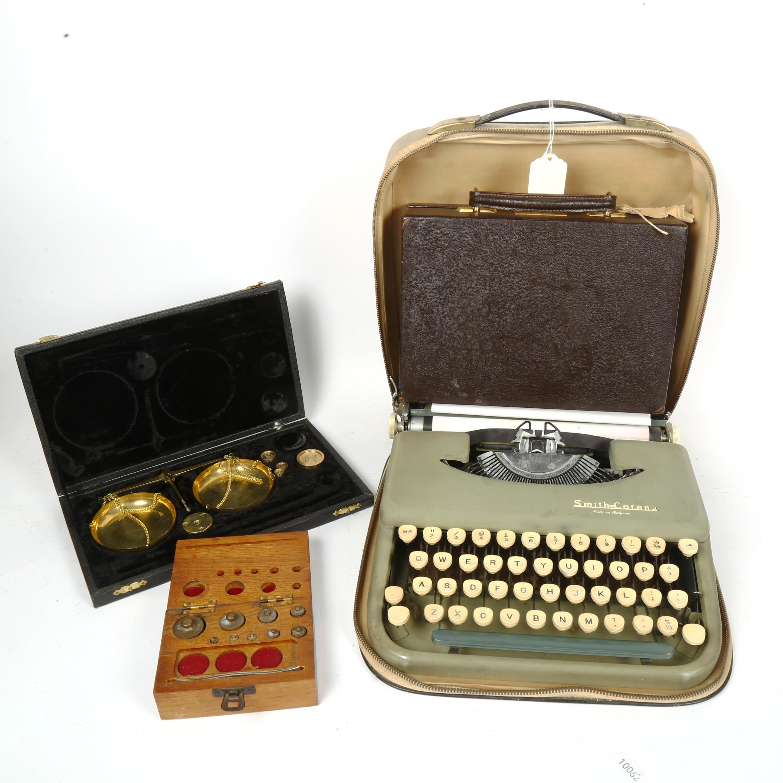A Smith Corona portable typewriter, 2 scales and weights, and a leather jewel case with tray