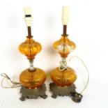 A pair of brass and amber glass table lamps, height excluding fitting 40cm