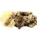 A sheepskin rug, and a snow leopard skin