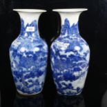 A pair of Chinese blue and white vases with lakeside scene, height 39cm