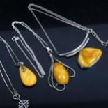 3 silver and custard coloured amber pendant necklaces