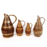 A graduated set of 4 copper-bound coopered oak jugs, tallest 25cm
