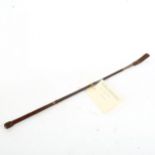 A leather riding crop, with handwritten note from Luca M Cumani of Bedford House Stables Suffolk,