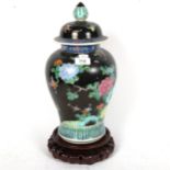 A Chinese carved jar and cover on carved wood stand, with bird and floral decoration, height 40cm