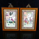 A pair of Chinese porcelain plaques, with hand painted scenes depicting figures in gardens, text