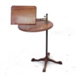An Antique mahogany music stand, with adjustable stand and integrated table, on cast-iron base