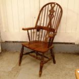 A pine seated bow-arm Windsor kitchen chair