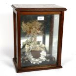 Antique wedding bouquet mounted in a glazed oak cabinet, height 39cm