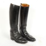 A pair of black leather horse riding boots