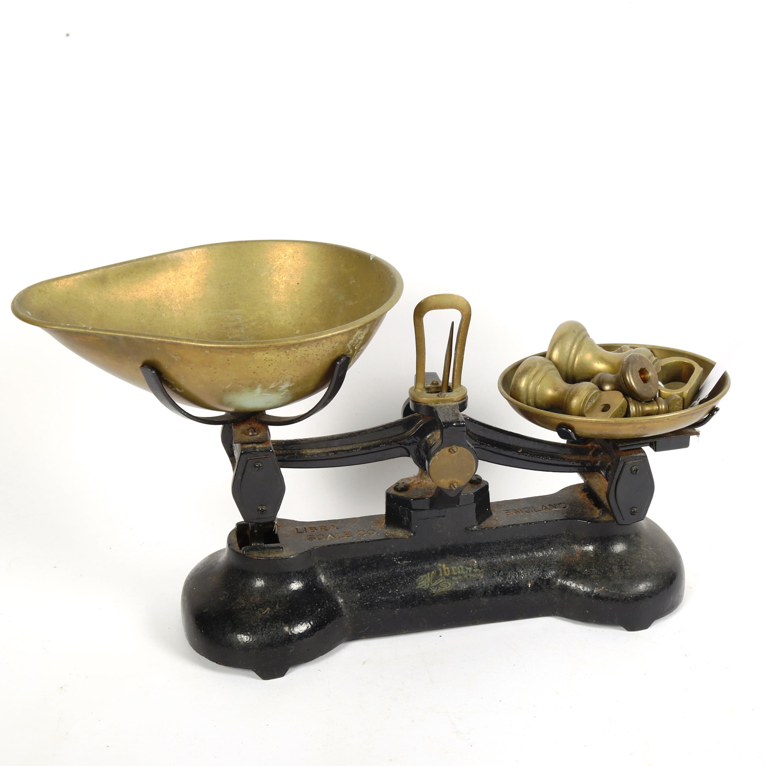 A pair of Libra cast-iron balance scales with weights, base length 32cm