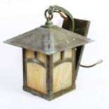 An Arts and Crafts style copper wall lantern, with mottled iridescent glass panels, height 35cm