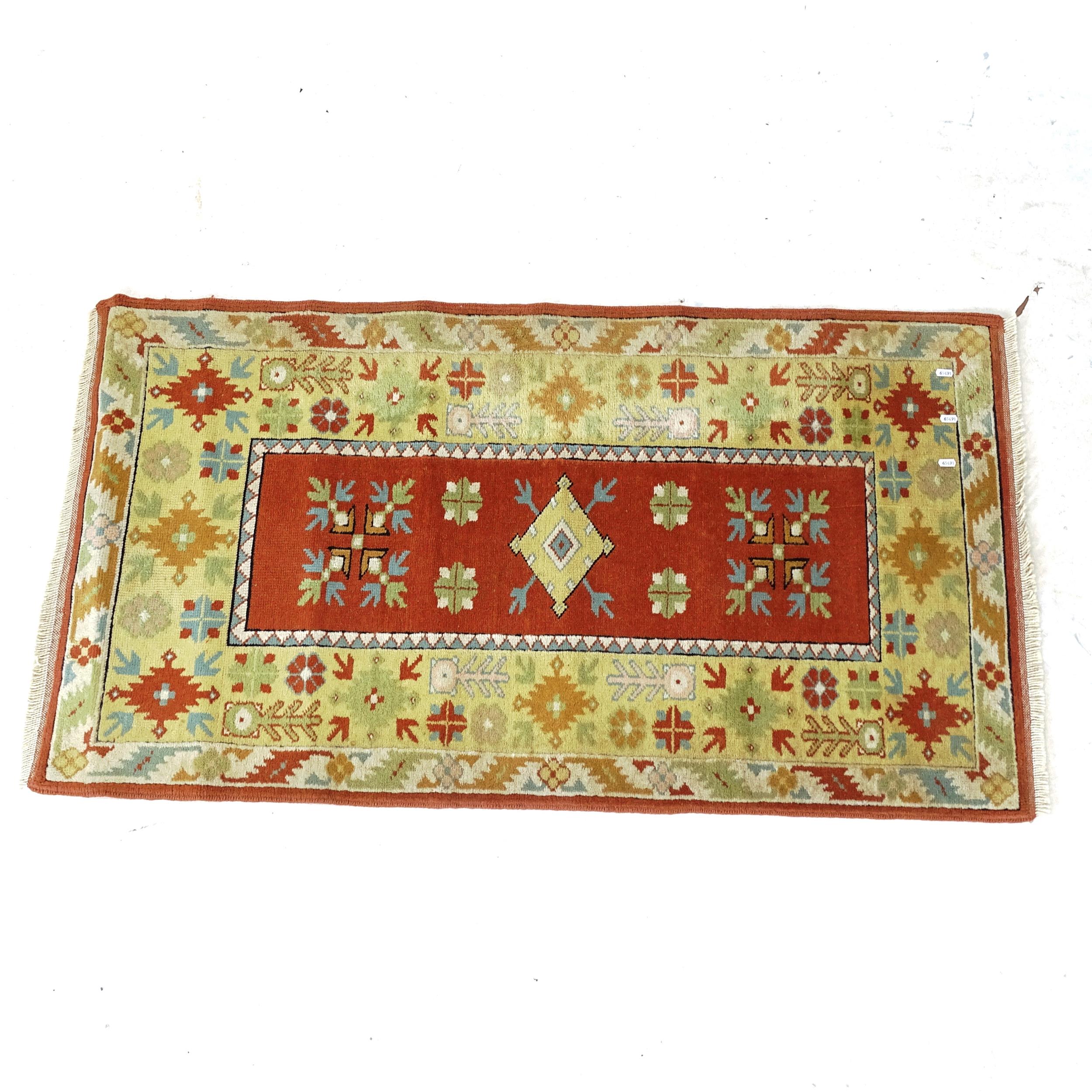 A yellow ground Afghan design rug, 140cm x 78cm