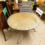 A circular painted metal garden table, and 4 folding garden chairs