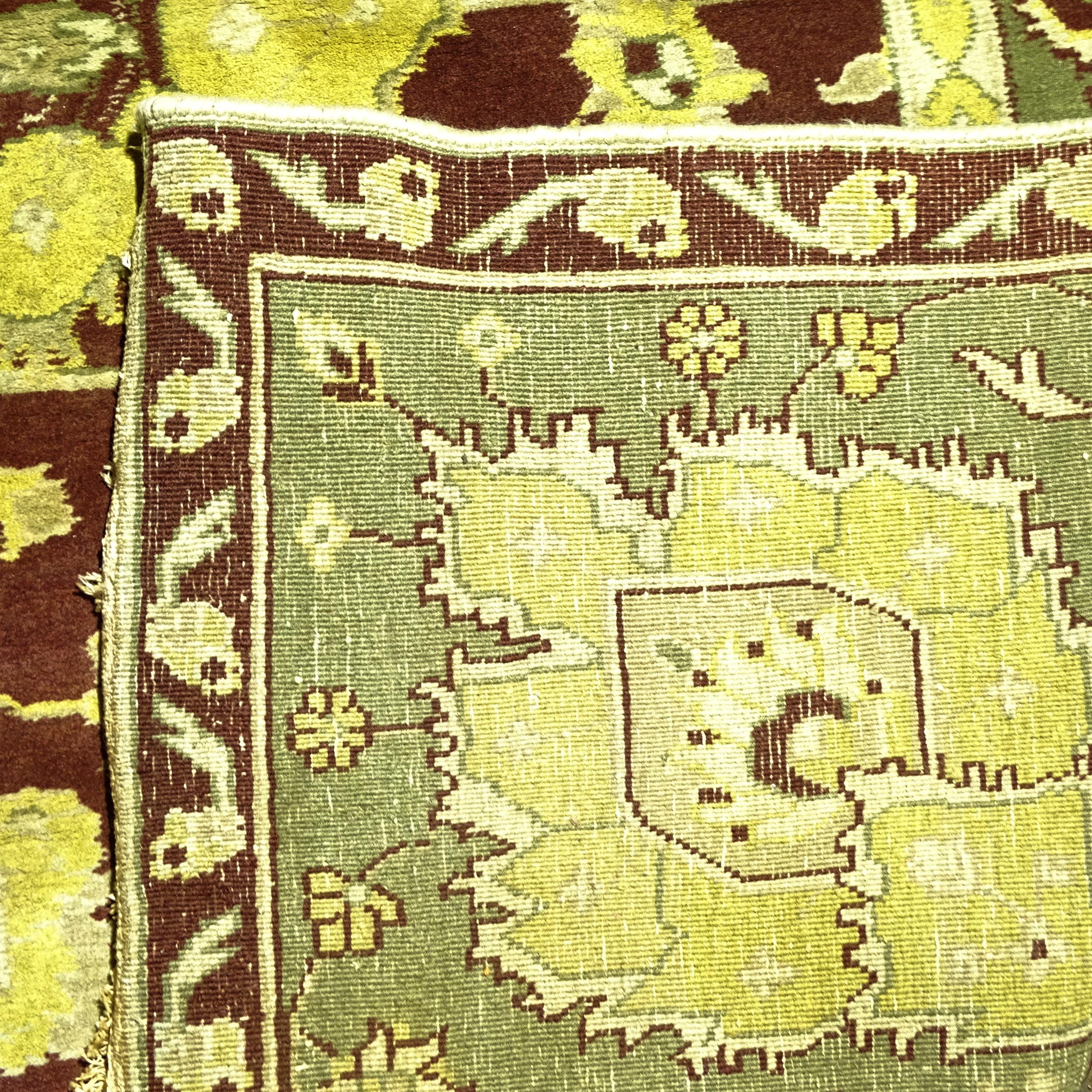 A green ground Persian design carpet, with a red and green border and red central lozenge, 300cm x - Image 2 of 2