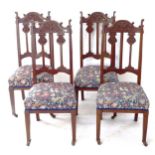 A set of 4 Arts and Crafts style tapestry upholstered dining chairs