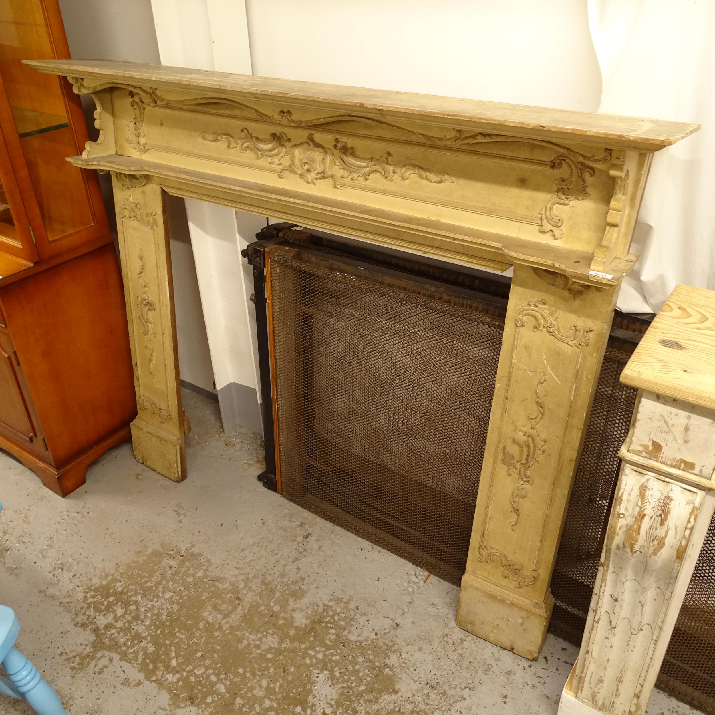 A Victorian painted pine fire surround, with applied scrolled decoration, W155cm, H130cm, rebate