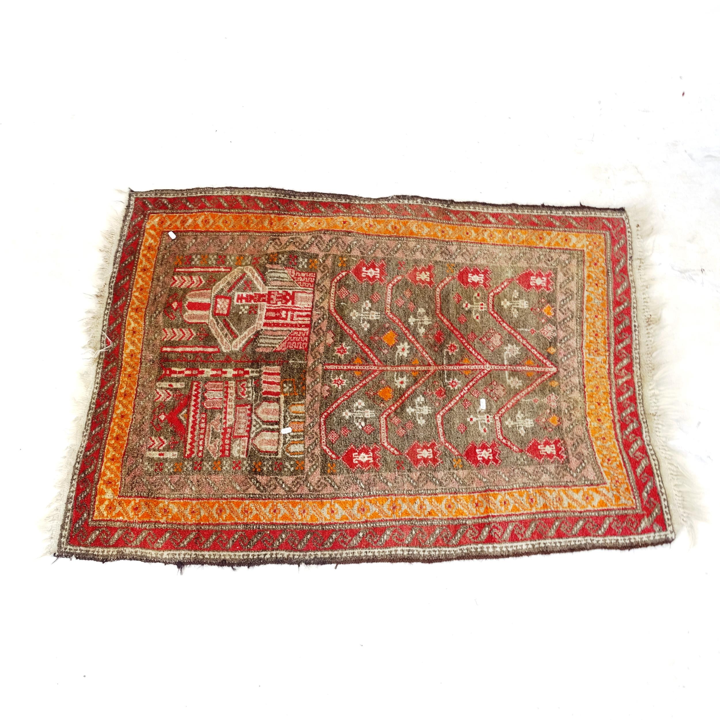 A red ground Persian rug, with tree design, 135cm x 100cm