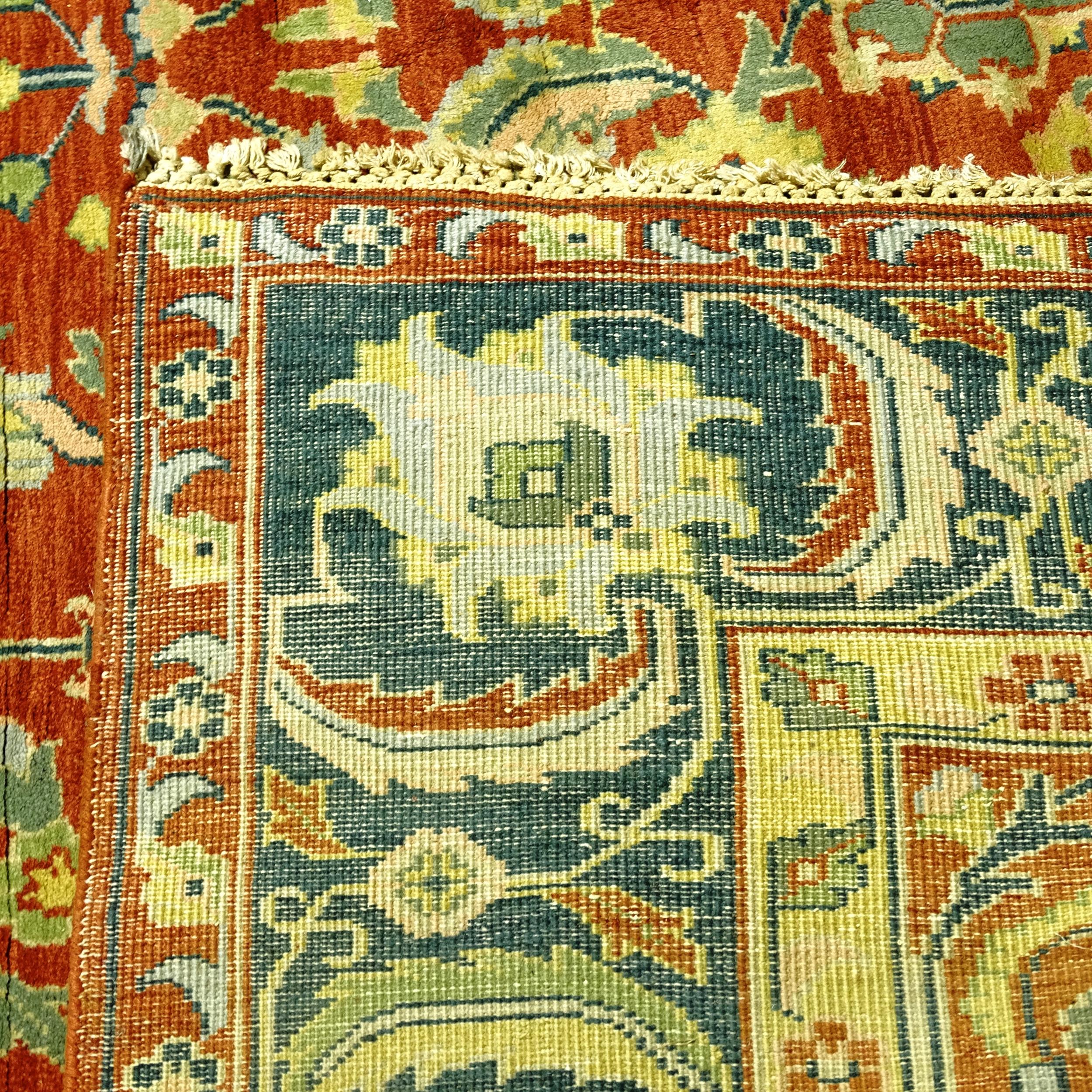 A large red ground Persian design carpet, with a red and green border and red ground lozenge, - Image 2 of 2