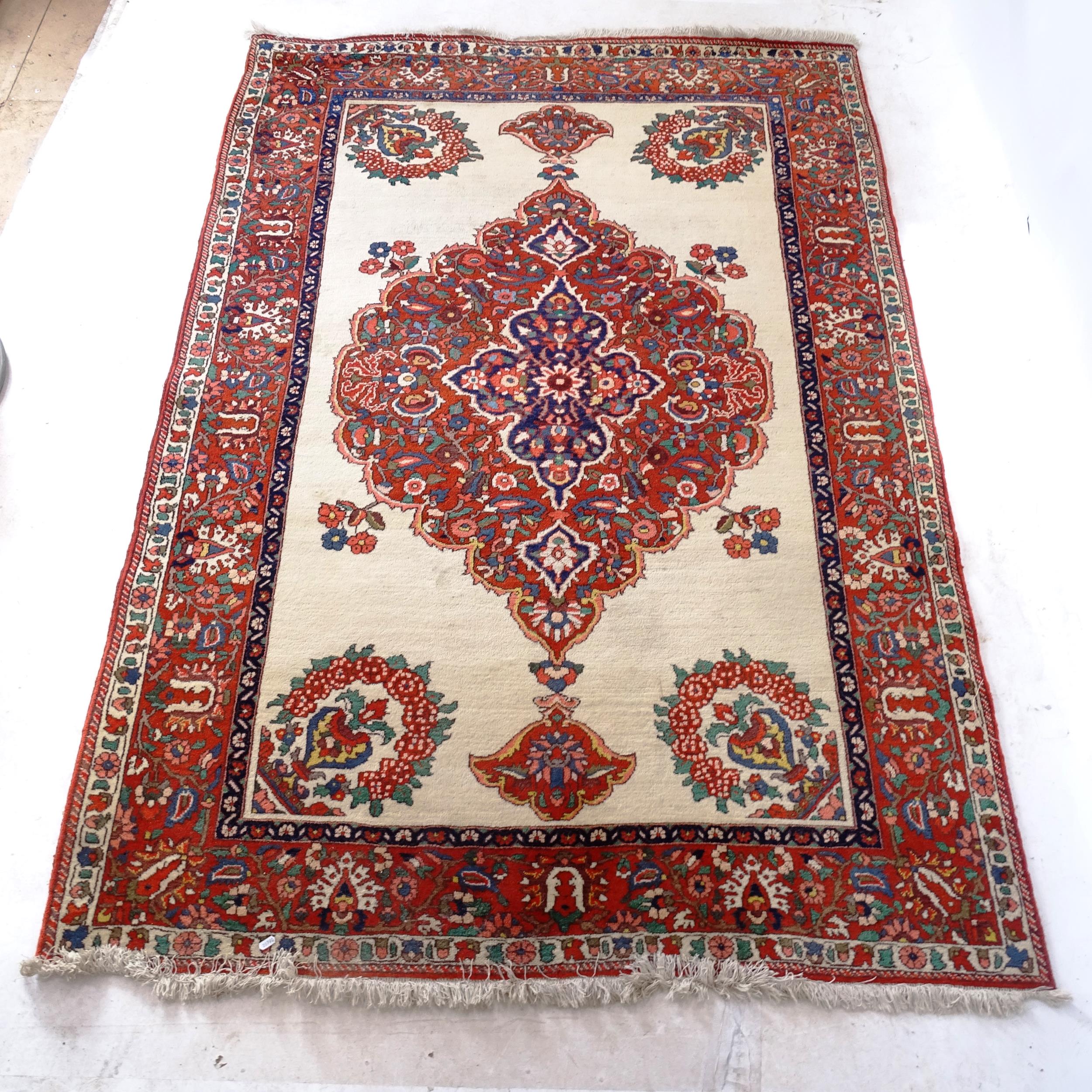 A red and cream ground Persian design rug, with symmetrical pattern and lozenge, 230cm x 160cm