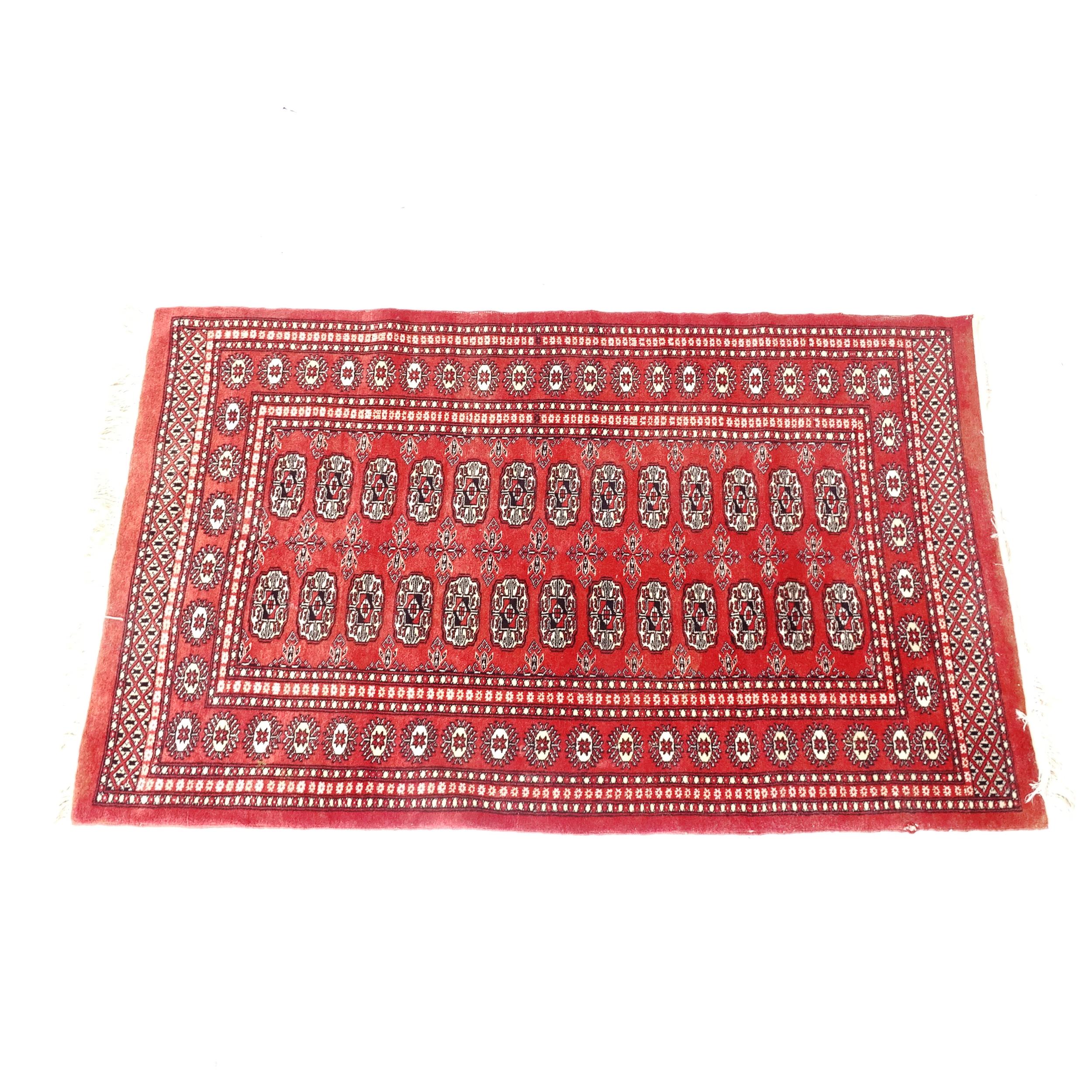 A red ground Tekke design rug, 155cm x 97cm