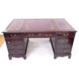 A reproduction mahogany veneered twin-pedestal writing desk, with a a 3-section red leather tooled