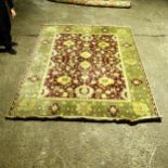 A green ground Persian design carpet, with a red and green border and red central lozenge, 300cm x