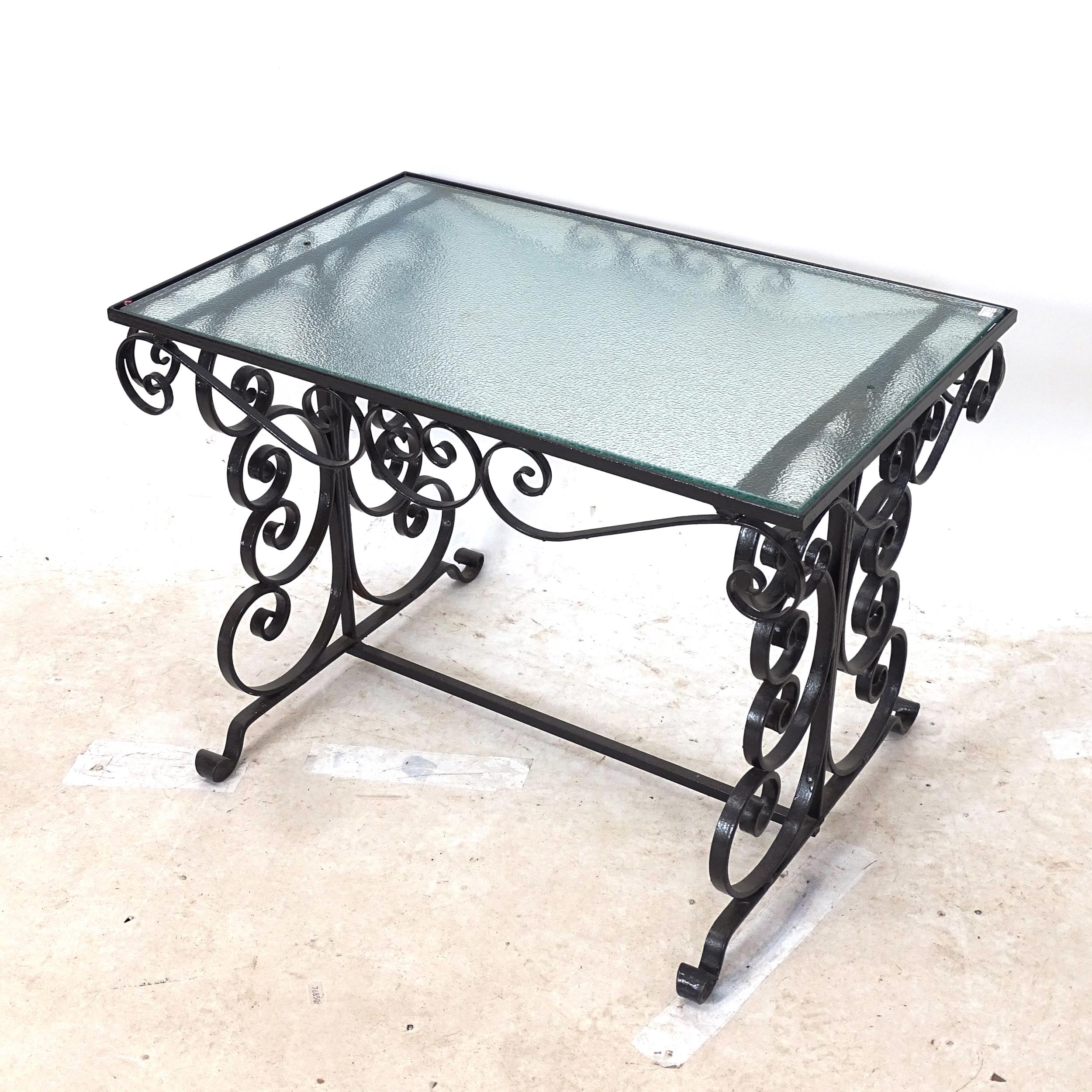 A mid-century Hollywood Regency wrought-iron coffee table, with rippled glass top, L67cm, H49cm,