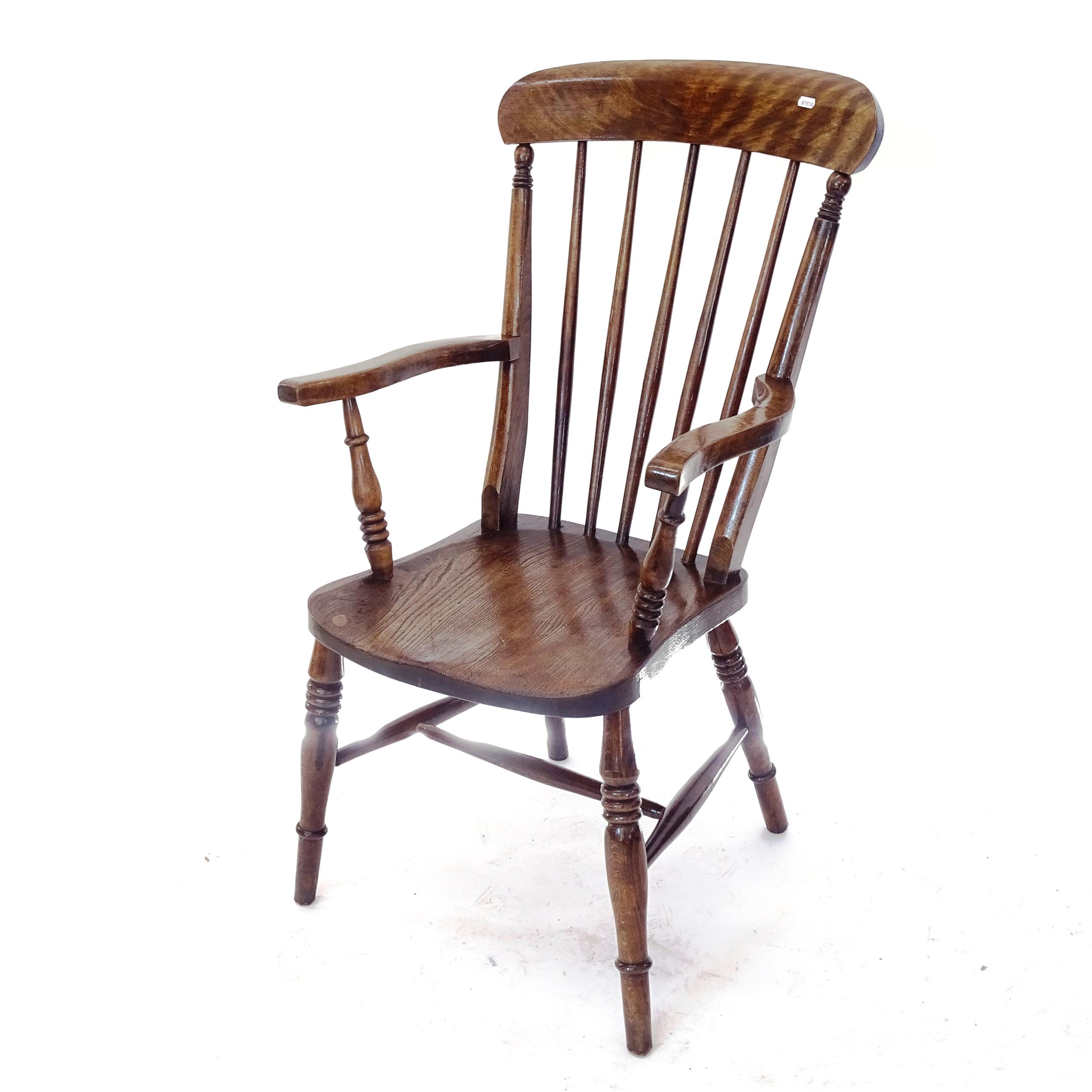A Victorian and oak elm seated Windsor kitchen armchair