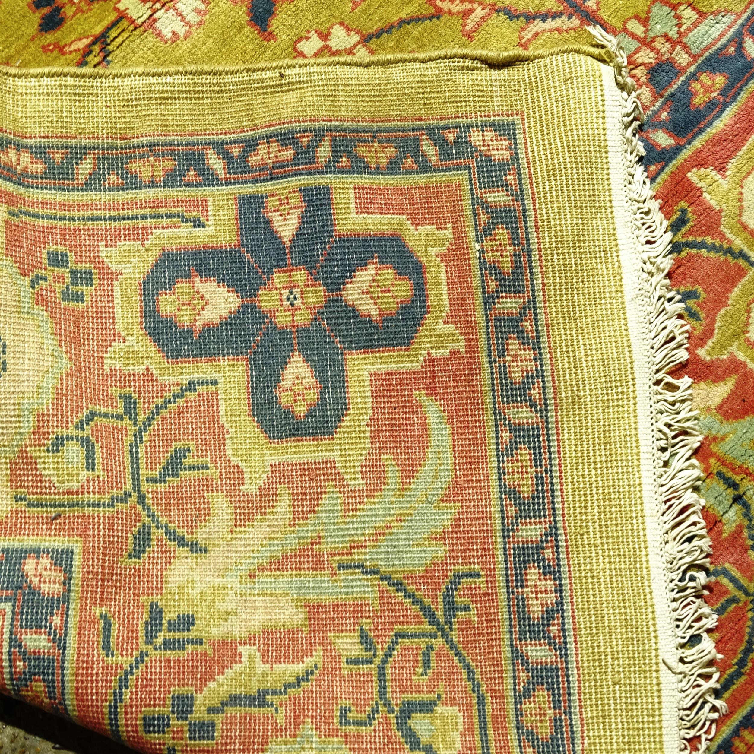 A large Persian design carpet, with a green and blue border and symmetrical floral lozenge, on a - Image 2 of 2