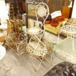 A painted wrought-iron oval folding garden table, and a pair of matching folding chairs