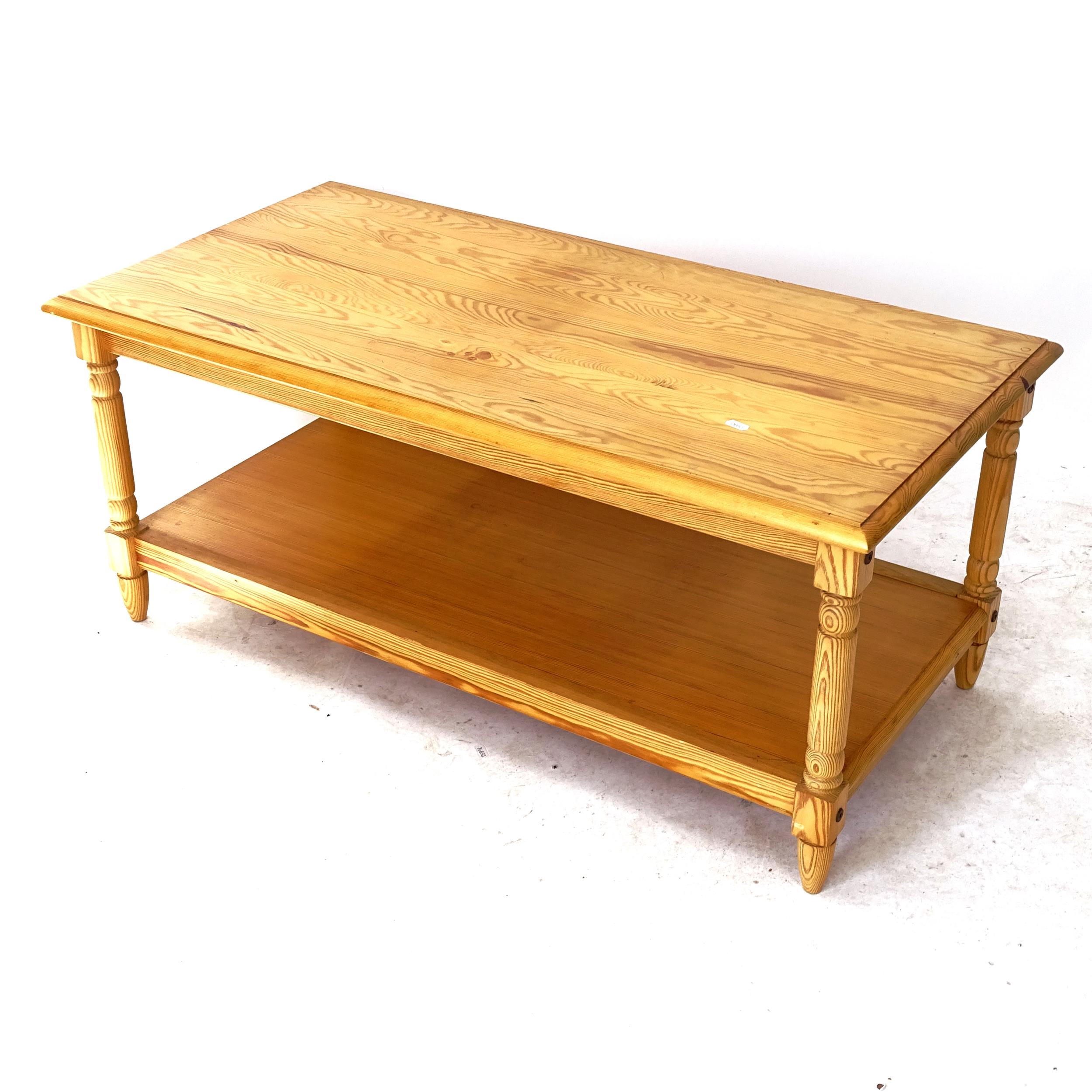 A modern pine 2-tier coffee table, on turned legs, L106cm, H46cm, D54cm