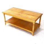 A modern pine 2-tier coffee table, on turned legs, L106cm, H46cm, D54cm