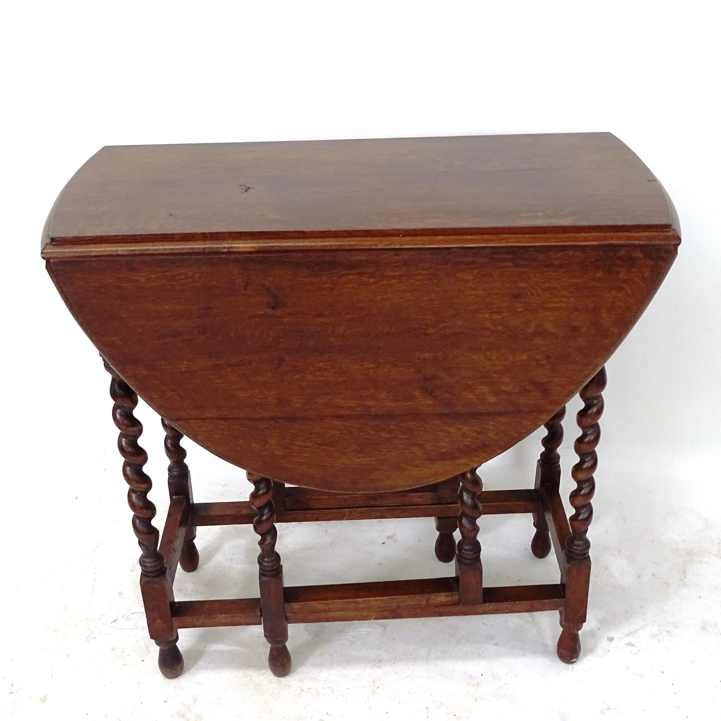 An oak oval barley twist gateleg table, W78cm, H73cm