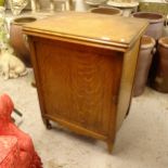 A Vintage New Home treadle sewing machine in fitted cabinet