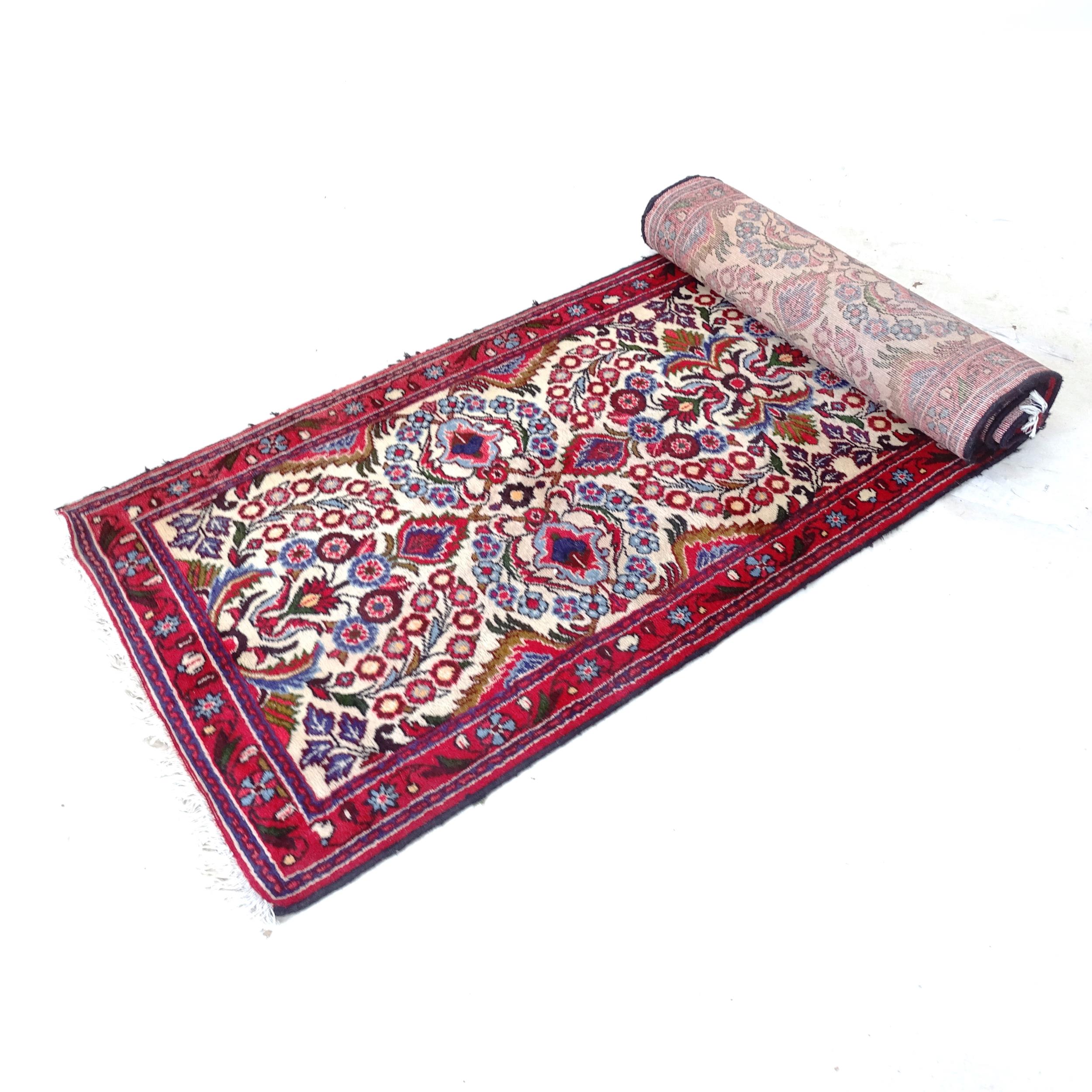 A red ground Persian design runner, 395cm x 78cm